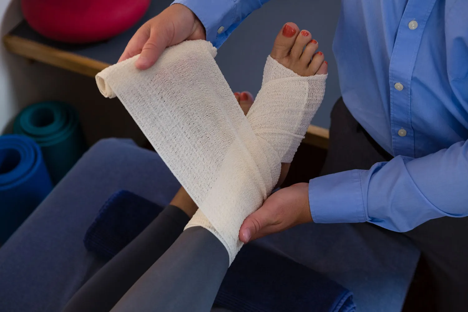 physiotherapist putting bandage on injured feet of 2023 11 27 05 12 54 utc